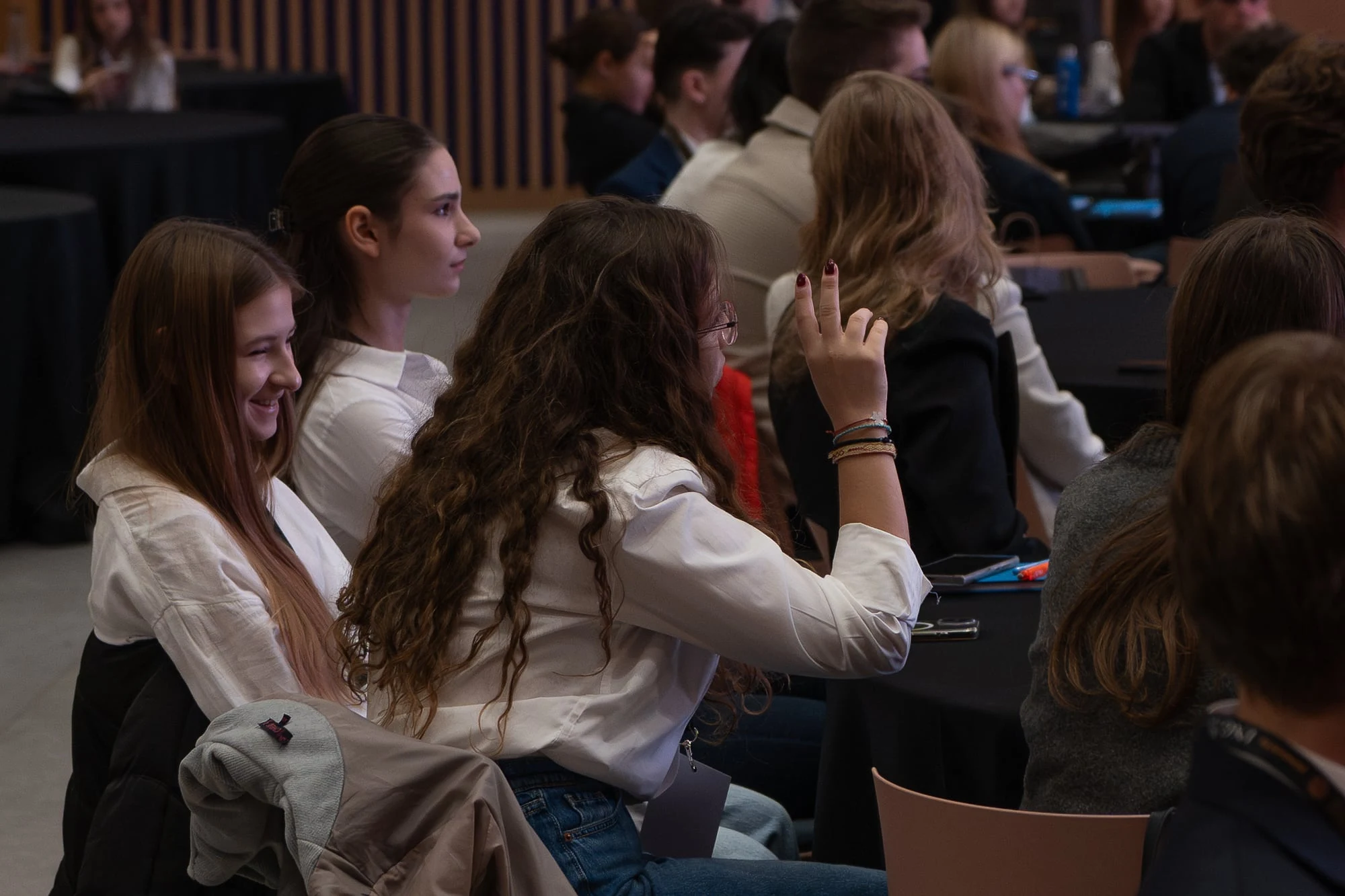 A participant raising her hand during FinMinds 2025