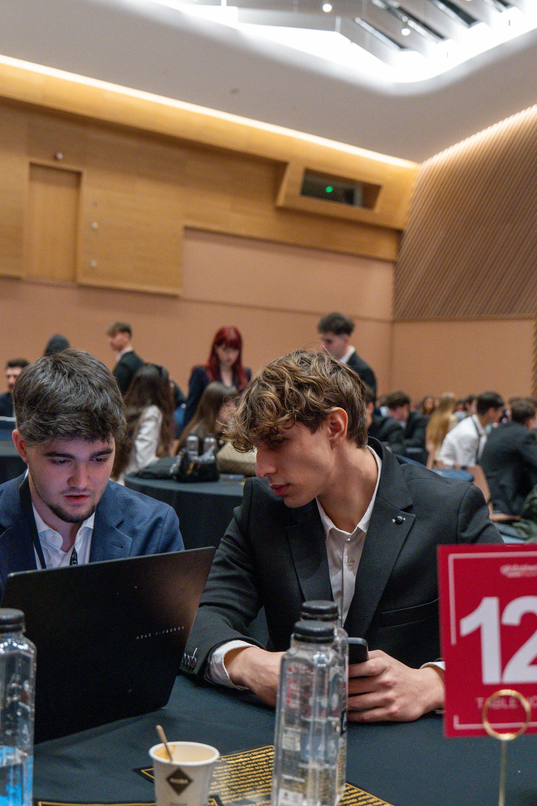 Two FinMinds 2025 participants working together on a laptop