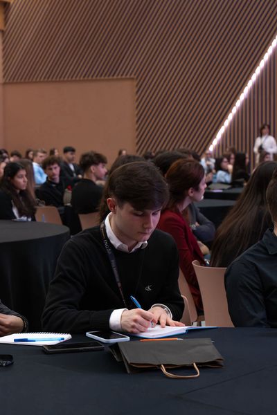 A FinMinds participant taking notes during a workshop session